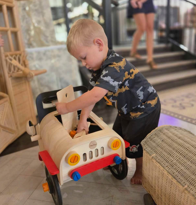 Young boy playing with a toy truck in an indoor kids play space in Greensburg, PA at The Trendy Bunny Studio