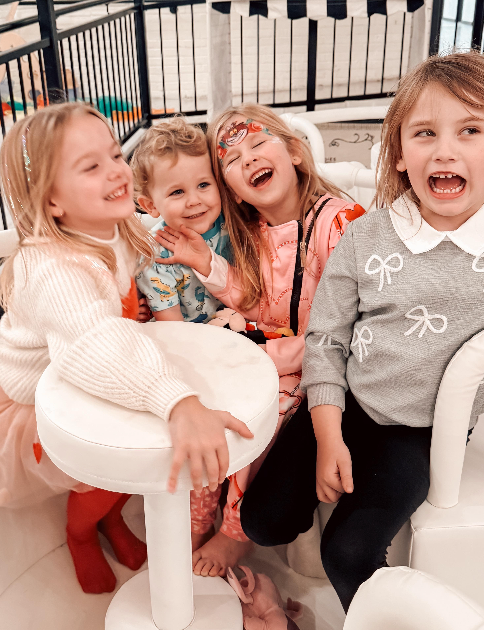 Group of children smiling and playing together at The Trendy Bunny Studio